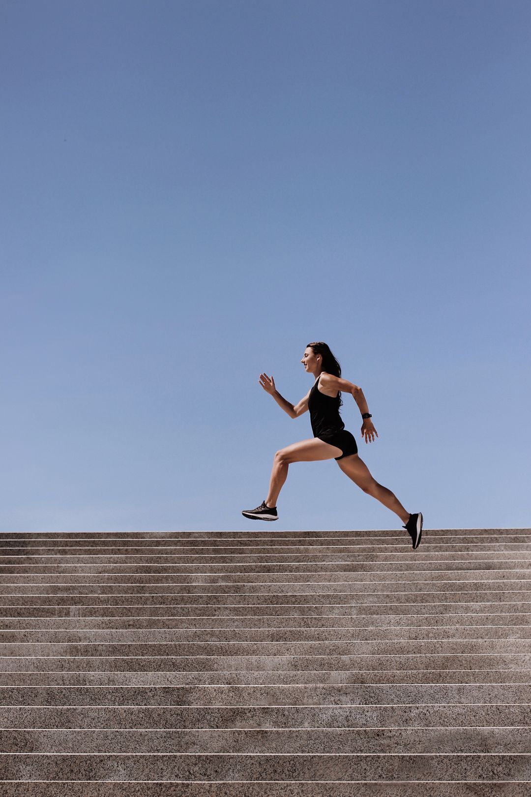 Runner in mid-stride on outdoor steps